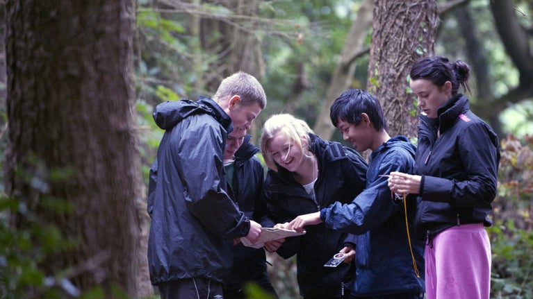 Visitors looking at a map whilst orienteering in the grounds of Castle Ward